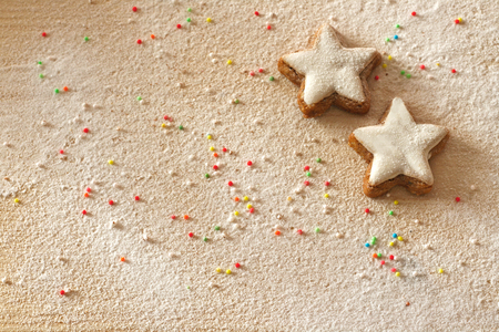 Christmas background with cinnamon stars, sprinkles and sugar as snowの写真素材