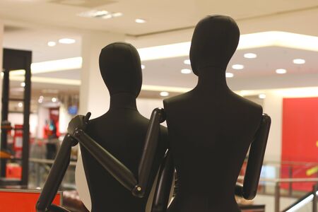 two display dummies, one putting the arm around the other, rear viewの写真素材