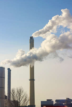 steam clouds from industry chimneys drifting lateral, blue sky
