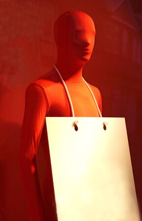 display dummy with a red morphsuit and a placard for text on red backgroundの写真素材