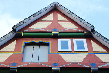 gable of a beautiful renovated half timbered house, Celle, Germany, with multi colored decorationsの写真素材