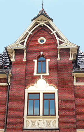 facade of a beautiful old brick stone house with decorative elements