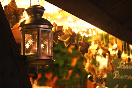 at a christmas market, warm atmosphere of a market stall with a burning lanternの写真素材