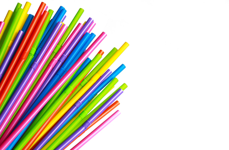 a bunch of multi colored plastic straws fanned out on white backgroundの写真素材