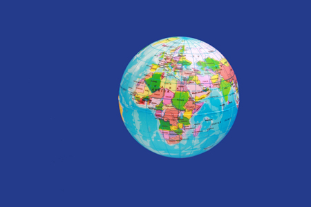 globe floating in front of a dark blue background, showing Europe and Africaの写真素材