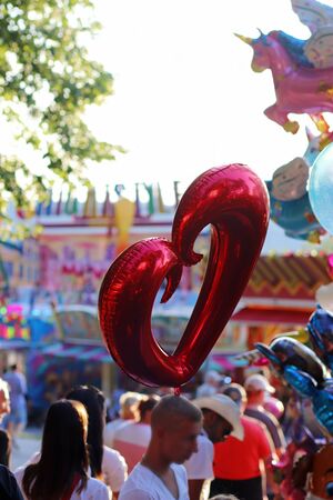 heart shaped balloon and a unicorn balloon at a funfairの写真素材
