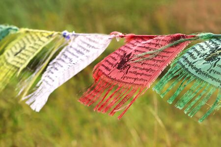 mulit colored Buddhist or Tibetan prayer flags waving in the wind