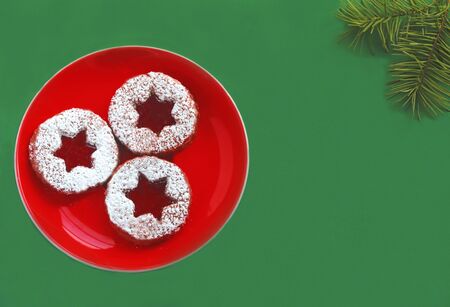 green and red christmas card with christmas cookies in star shape, top view with copy space