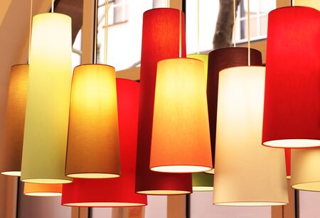 group of multi colored lamps hanging side by side