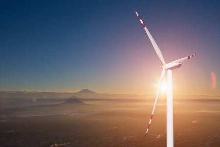 Wind generator on a background of sunset sky. Clean energy concept