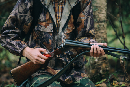 Classic vertical two barrels hunting rifle in hunters hand