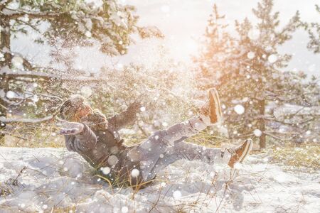 Girl in winter park, snowy forest. Snowfall.の写真素材
