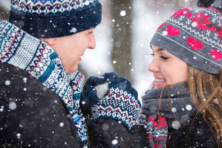 A loving couple walking in winter park.の写真素材