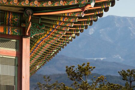 Traditional Korean building on a background of mountains.の写真素材