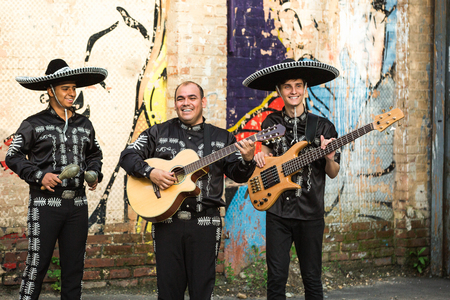 Mexican musicians in traditional costumes mariachi on the streets of the cityの写真素材