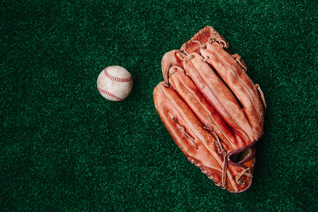 Old leather glove of the baseball catcher and the ballの写真素材