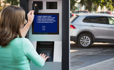 Woman pays for parking with a credit cardの写真素材
