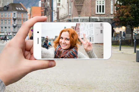 Woman traveler communicates via a smartphone app video call.