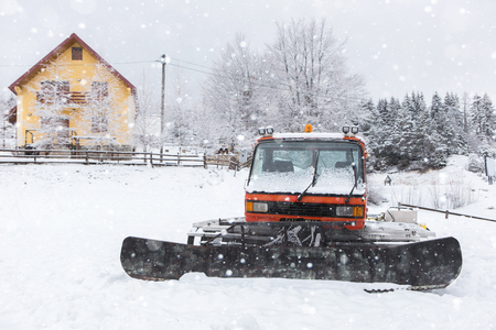 Red snowcat bulldozer on the mountains ski resortの写真素材