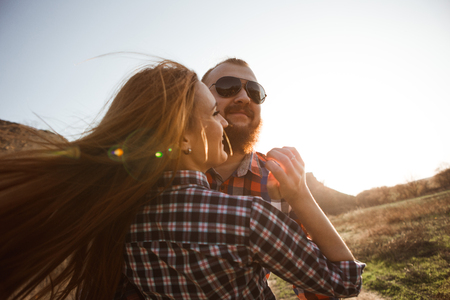 Loving couple walking in mountains park. Girl with read hair, boy with beard.の写真素材