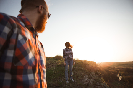 Loving couple walking in mountains park. Girl with read hair, boy with beard.の写真素材