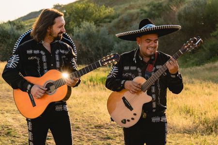 Mexican musicians mariachi in traditional costumes at sunsetの写真素材