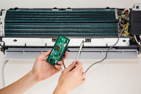 Service man is cleaning, repair and maintenance of air conditionerの写真素材