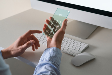 Man uses a futuristic transparent smart phoneの写真素材