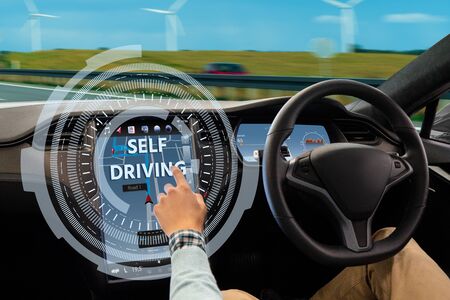 Man turns on autonomous driving modeの写真素材