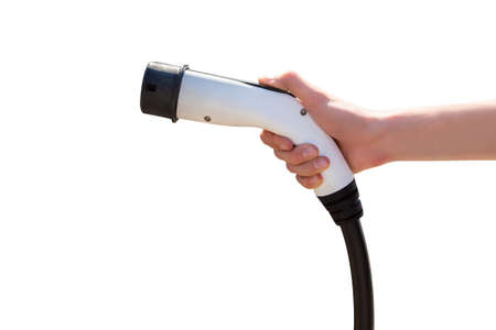 Hand with charger for electric car isolated on white backgroundの写真素材