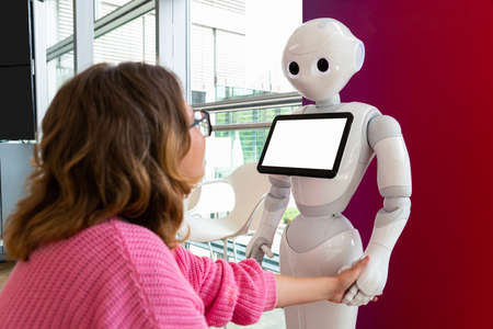 A woman communicates with a robot consultantの写真素材