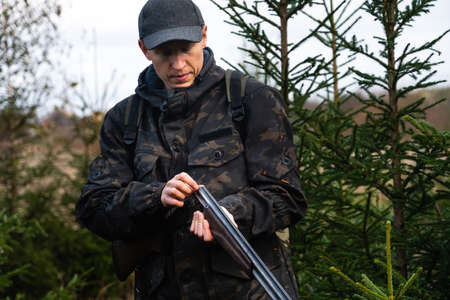 Hunter with a gun and a backpack