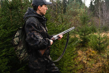 Hunter with a gun and a backpack