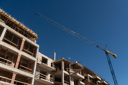 Construction of a building with a remotely controlled unmanned crane