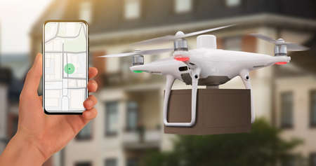 Hand with phone on background of delivery drone