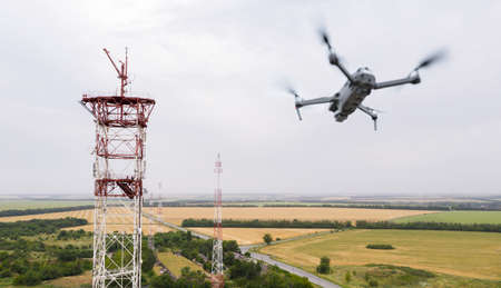 Drone flies over telecommunication towers in the countryside