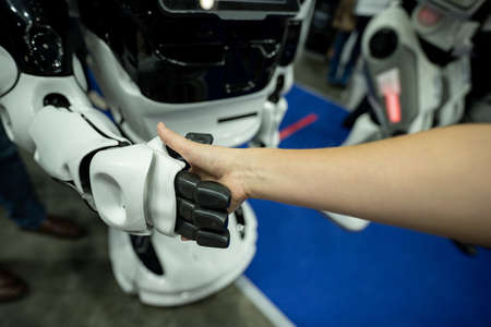 Shaking hands with robotの写真素材