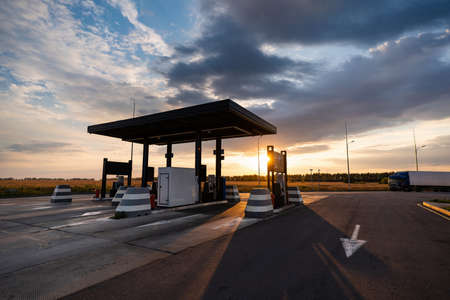 Modern self service gas station against the backdrop of a dramatic sunset skyの写真素材