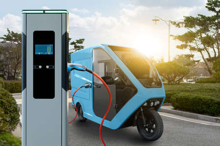 Concept of green delivery electric tricycle scooter with charging station on a background of...