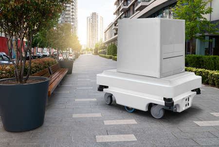 Delivery robot transporting a box on the street. conceptの写真素材