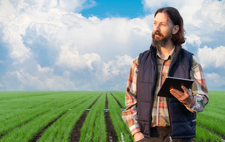 Farmer with digital tablet on a field. Smart farming and digital agricultureの写真素材