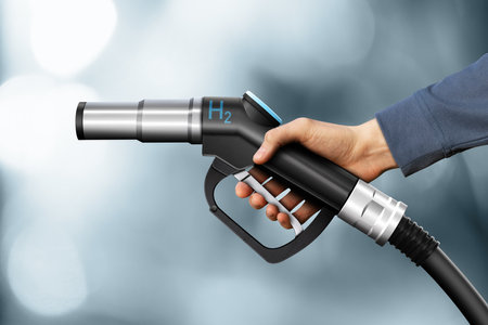 Hand with hydrogen fueling nozzle on a gray backgroundの写真素材