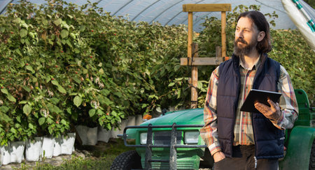 Farmer with digital tablet on an agricultural field. Smart farming and digital agriculture