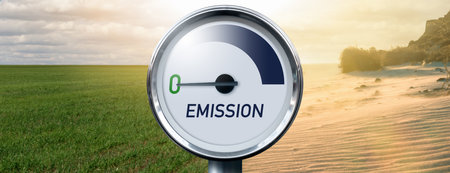 Gauge with inscription EMISSION and arrow points to zero on a background of landscape with half...
