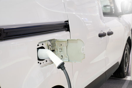 Electric delivery van with connected charging cable.の写真素材
