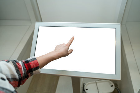 Woman uses the self-service kiosk in the store.の写真素材