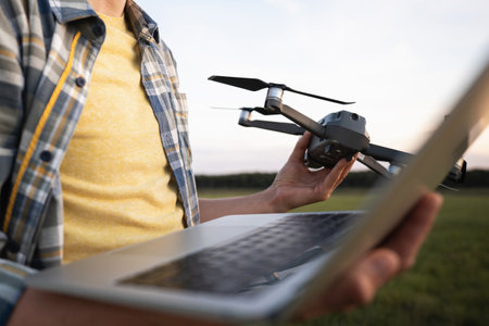 Farmer with laptop and drone on the field. Smart farming and agriculture digitalization.. High quality photoの写真素材