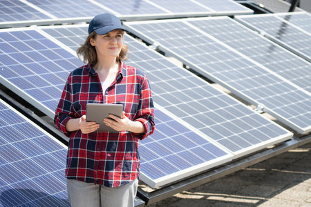 Woman with digital tablet on a background of mobile solar power station