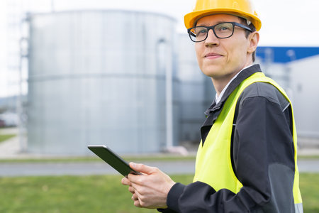 Engineer with digital tablet on a background of gas tanks.の写真素材