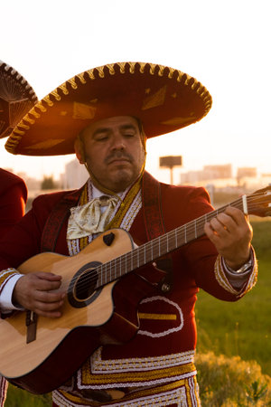 Mexican musician mariachi plays the guitar on a city street.